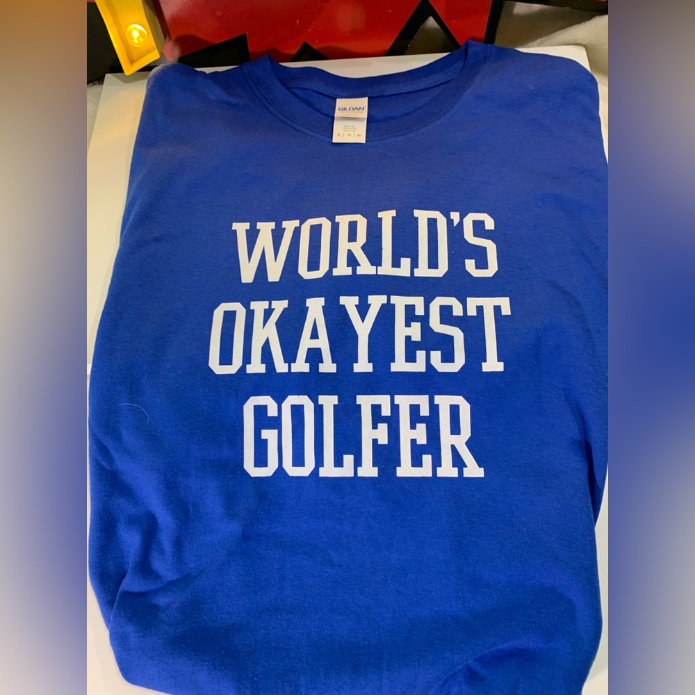“World’s Okayest Golfer”
Men’s XL T-Shirt
Blue with White Letters
Used Like New
